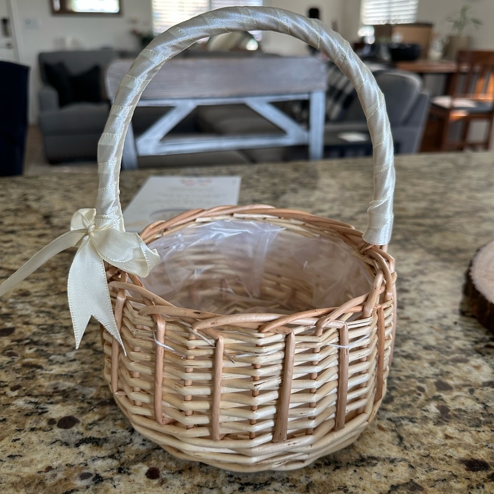 Woven basket/flower girl basket with plastic lining.